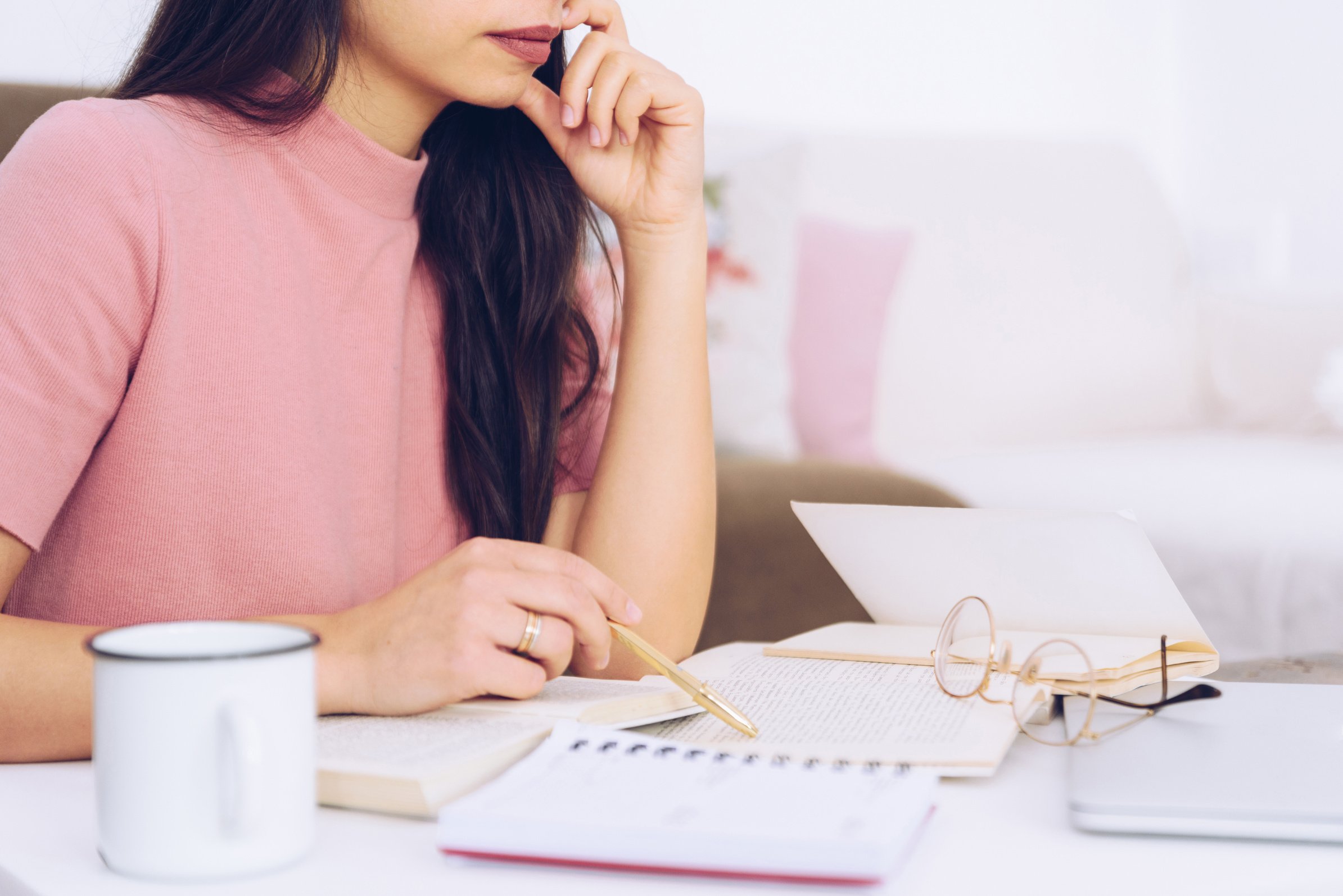 Young Woman in Pink Studying